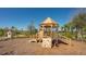 Wooden playground structure with climbing wall, slide, and lookout tower on a wood chip surface at 10109 Milky Way Cir, Sarasota, FL 34241