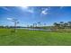 Picturesque view of a lush green lawn leading to a tranquil pond, enhancing the property's serene ambiance at 10109 Milky Way Cir, Sarasota, FL 34241