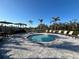 Relaxing spa pool surrounded by lounge chairs and umbrellas, set against a tranquil landscape at 10109 Milky Way Cir, Sarasota, FL 34241