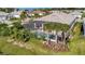 Luxury home with private pool and screened enclosure, lush landscaping at 10201 Beach Dune Dr, Englewood, FL 34223