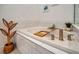 Relaxing bathroom with soaking tub and tray at 10201 Beach Dune Dr, Englewood, FL 34223