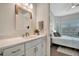 Clean bathroom with white vanity and walk-in shower at 10201 Beach Dune Dr, Englewood, FL 34223