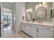 Elegant bathroom with double vanity and a view of bedroom at 10201 Beach Dune Dr, Englewood, FL 34223