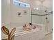 Spa-like bathroom with soaking tub and walk-in shower at 10201 Beach Dune Dr, Englewood, FL 34223