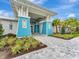 Community clubhouse entrance with attractive landscaping and a welcoming walkway at 10201 Beach Dune Dr, Englewood, FL 34223