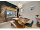 Elegant dining room with wood table, statement wall, and chandelier at 10201 Beach Dune Dr, Englewood, FL 34223