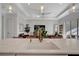 Kitchen island with white quartz countertop, gold faucet, and view to living area at 10201 Beach Dune Dr, Englewood, FL 34223