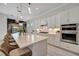 Bright kitchen with white cabinets, quartz countertops, and double ovens at 10201 Beach Dune Dr, Englewood, FL 34223