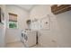 Laundry room with washer, dryer, and shelving at 10201 Beach Dune Dr, Englewood, FL 34223