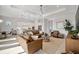 Bright and airy living room with leather seating and open kitchen at 10201 Beach Dune Dr, Englewood, FL 34223