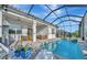 Relaxing pool area with covered patio, seating, and dining area at 10201 Beach Dune Dr, Englewood, FL 34223