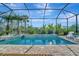 Enjoy this screened pool and spa with pavers at 10201 Beach Dune Dr, Englewood, FL 34223