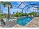 Relaxing screened pool and spa with brick pavers at 10201 Beach Dune Dr, Englewood, FL 34223