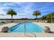 Relaxing pool with surrounding lounge chairs and palm trees at 10510 Boardwalk Loop # 404, Bradenton, FL 34202