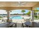 Resort-style pool with lounge chairs, covered patio, and lake views at 10510 Boardwalk Loop # 404, Bradenton, FL 34202