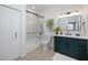 Modern bathroom with green vanity and glass shower at 11124 Sanctuary Dr, Bradenton, FL 34209