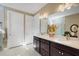 Double vanity bathroom with dark brown cabinets and a large mirror at 12366 Marsh Pointe Rd, Sarasota, FL 34238