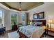 Main bedroom with leafy patterned bedding and hardwood floors at 12366 Marsh Pointe Rd, Sarasota, FL 34238