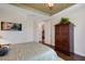 Bedroom with leafy patterned bedding and access to hallway at 12366 Marsh Pointe Rd, Sarasota, FL 34238