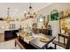 Bright dining room featuring a farmhouse-style table and chandelier at 12366 Marsh Pointe Rd, Sarasota, FL 34238