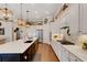 Modern kitchen with white cabinets, quartz countertops, and a large island at 12366 Marsh Pointe Rd, Sarasota, FL 34238