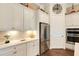 Well-equipped kitchen with white cabinets and stainless steel appliances at 12366 Marsh Pointe Rd, Sarasota, FL 34238