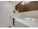 Laundry room with washer, dryer, and ample cabinet space at 12366 Marsh Pointe Rd, Sarasota, FL 34238