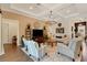 Bright living room featuring comfortable seating, a large TV, and a cozy rug at 12366 Marsh Pointe Rd, Sarasota, FL 34238