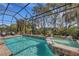 Large screened pool and spa, surrounded by lush landscaping at 12366 Marsh Pointe Rd, Sarasota, FL 34238