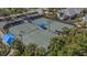 Two lighted tennis courts with shade structure at 12366 Marsh Pointe Rd, Sarasota, FL 34238