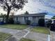 Tan house with a spacious yard and a long driveway at 1308 W Cypress St, Tampa, FL 33606