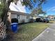 Tan house with a spacious yard and a blue recycling bin at 1308 W Cypress St, Tampa, FL 33606