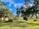 Landscaped backyard with a pond and lush greenery at 1414 6Th W St, Palmetto, FL 34221