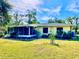 Side exterior view of the house and screened porch at 1414 6Th W St, Palmetto, FL 34221