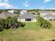 Aerial view of a house with a large backyard, showcasing the property and surrounding neighborhood at 14822 Trinity Fall Way, Bradenton, FL 34212