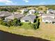 Aerial view showcasing a house with a pool and screened enclosure in a lakefront community at 14822 Trinity Fall Way, Bradenton, FL 34212