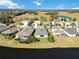 Aerial view of a community of houses near a lake, showcasing different architectural styles at 14822 Trinity Fall Way, Bradenton, FL 34212