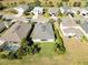 Aerial view of a residential area with houses and a lake, showing a house with a backyard at 14822 Trinity Fall Way, Bradenton, FL 34212