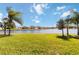 Spacious backyard with lake view and lush landscaping at 14822 Trinity Fall Way, Bradenton, FL 34212