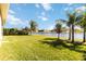 Spacious backyard with lake view and lush landscaping at 14822 Trinity Fall Way, Bradenton, FL 34212