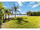 Spacious backyard with lake view and lush landscaping at 14822 Trinity Fall Way, Bradenton, FL 34212