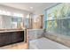 Bathroom with granite countertop, dark brown vanity, and a large walk-in shower at 14822 Trinity Fall Way, Bradenton, FL 34212