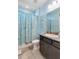 Light blue bathroom with granite countertop, dark brown vanity, and shower/tub at 14822 Trinity Fall Way, Bradenton, FL 34212