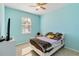 Light blue bedroom with a double bed and window at 14822 Trinity Fall Way, Bradenton, FL 34212