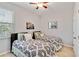 Bedroom with two twin beds, ceiling fan, and wall art at 14822 Trinity Fall Way, Bradenton, FL 34212