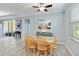 Charming dining area with a wooden table and four chairs, featuring a lovely wall art at 14822 Trinity Fall Way, Bradenton, FL 34212