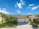 House exterior with three-car garage and palm trees at 14822 Trinity Fall Way, Bradenton, FL 34212