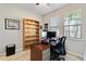 Home office features built-in shelving and a spacious desk area at 14822 Trinity Fall Way, Bradenton, FL 34212