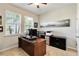 Home office features built-in shelving, a desk, and plenty of natural light at 14822 Trinity Fall Way, Bradenton, FL 34212