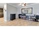 Living room with tile floors, large mirror and built-in shelving at 14822 Trinity Fall Way, Bradenton, FL 34212